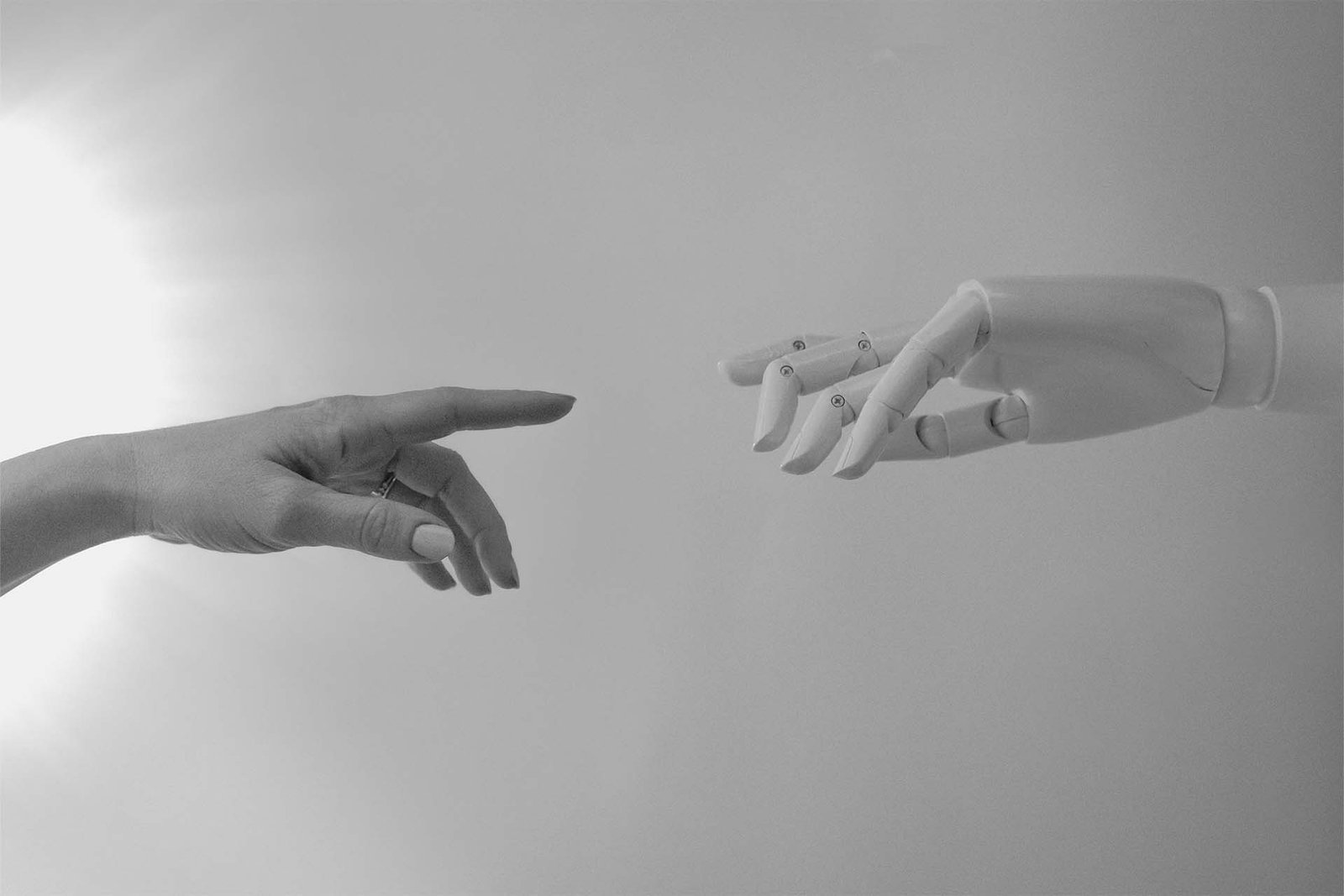 Human and robot hands about to touch